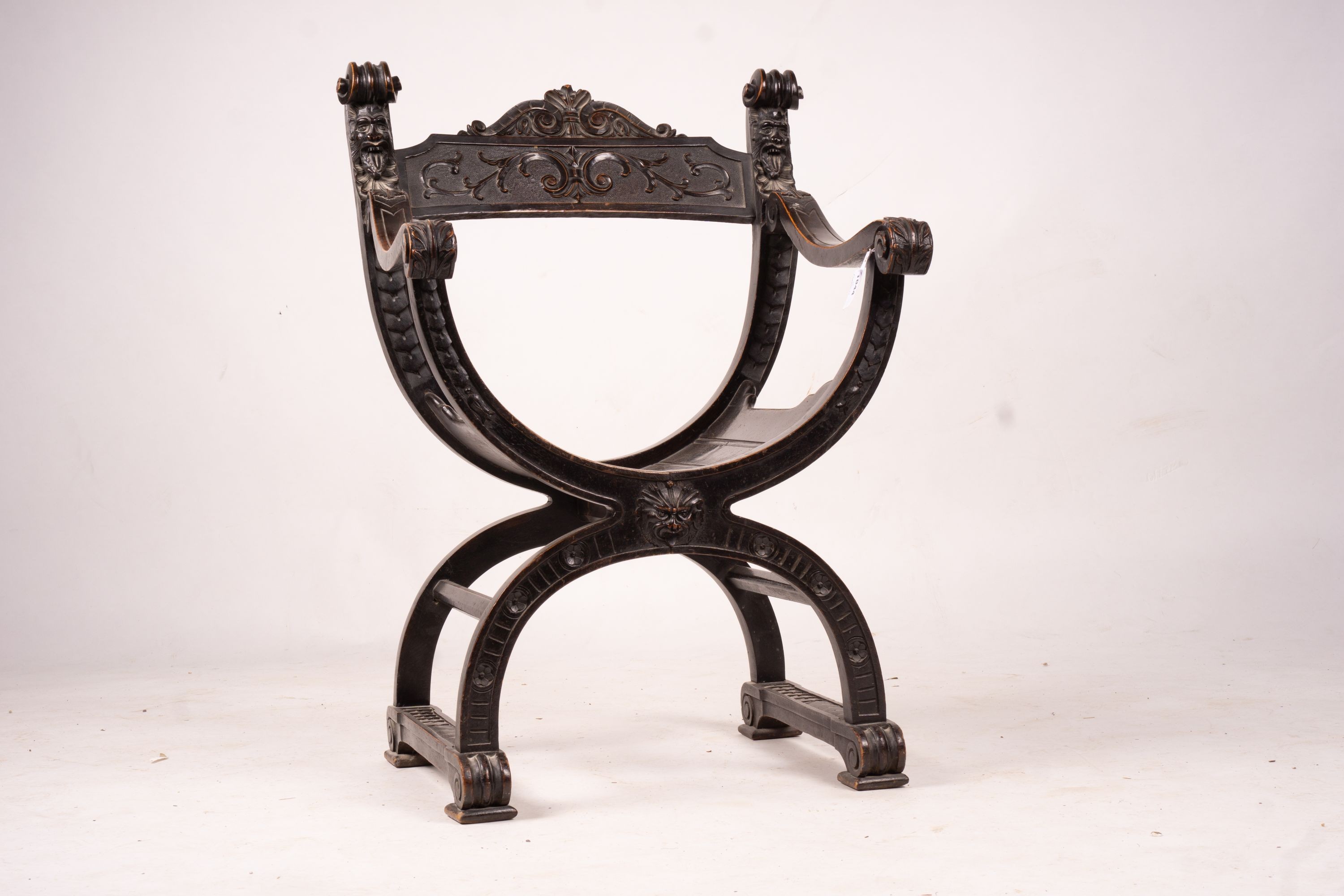 An ebonised Sagrada style elbow chair